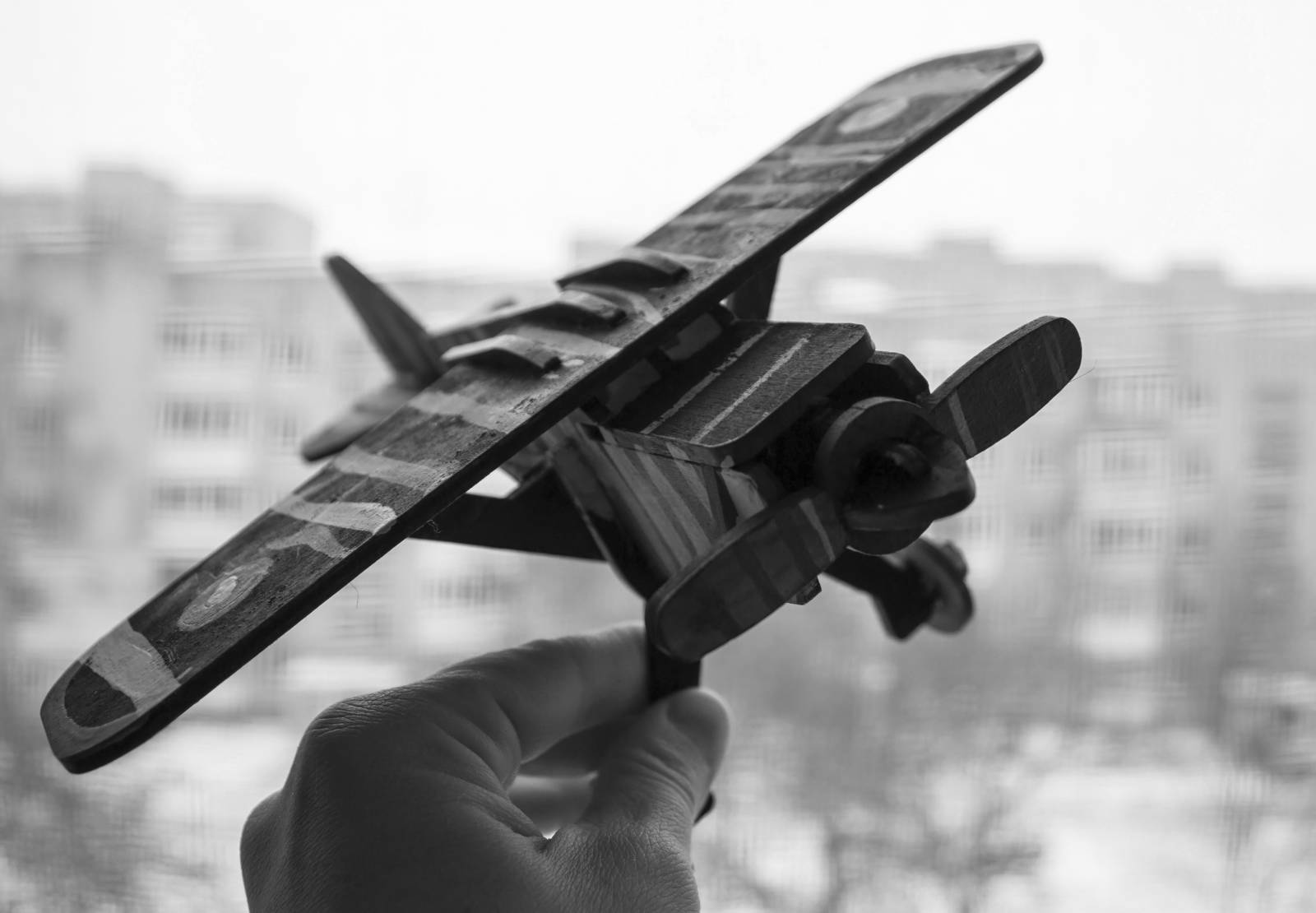 A hand holding a model aircraft
